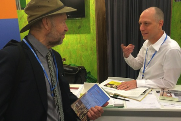 Dr. James Hansen speaking with Dr. Michael Gillenwater at GHGMI exhibit. Photo credit: J. Niles.