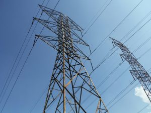 Power lines sit against a blue sky.
