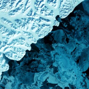 Aerial shot of a glacier. The photo is composed to appear cut in half, but in reality, it is the contrast of the glacier's shadow creating this artistic effect.