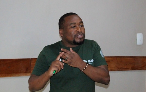 2025 GHGMI scholarship recipient is pictured speaking and gesturing.